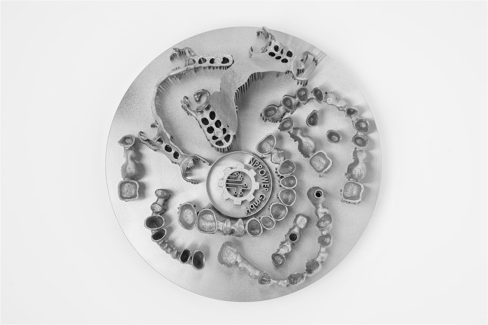 Top view of a full Ø125 mm Malachite build plate packed with printed dental parts